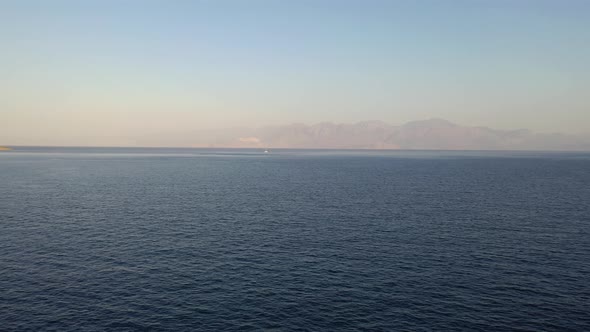 Aerial View of a Motor Boat in a Deep Blue Colored Sea. Kolokitha Island, Crete, Greece