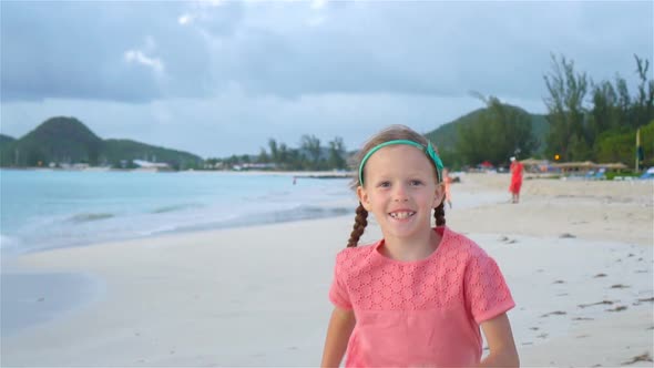 Cute Little Girl in Hat at Beach During Caribbean Vacation