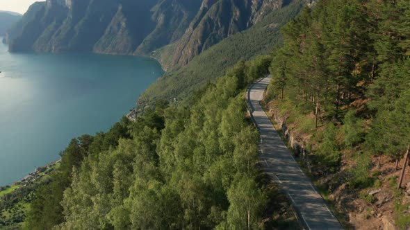 Drone Flight Over Road By River Valley alt