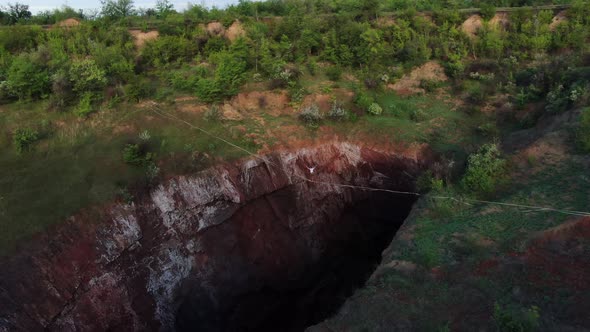 Man Is Walking on a Slackline Extreme Sport View on the Nature Film Grain alt