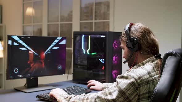 Male Gamer with Long Hair Can't Believe He Lost While Playig Shooter Games alt