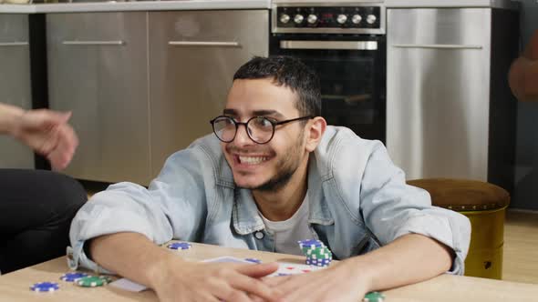 Man winning poker game with friends