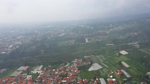 Aerial view of a foggy farm field in suburban area in Asia country