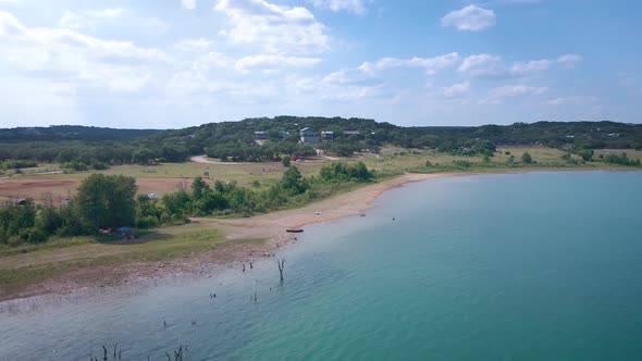 Aerial shots of a lake park in Texas on the popular Canyon Lake while barely any boats are cruising alt