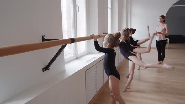 Ballet Coach Teaching Little Girls in Studio alt
