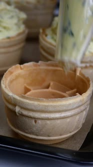 Chef Hands in Rubber Protective Gloves Take White Chicken Eggs From Cardboard Eggs Tray alt