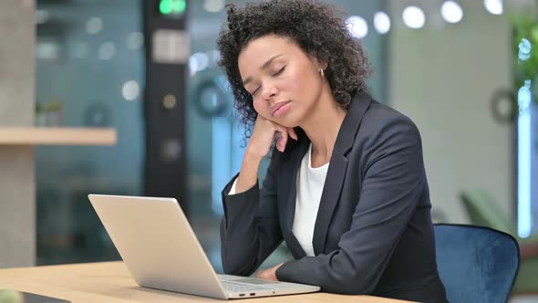 African Businesswoman Sleeping in Office at Desk alt