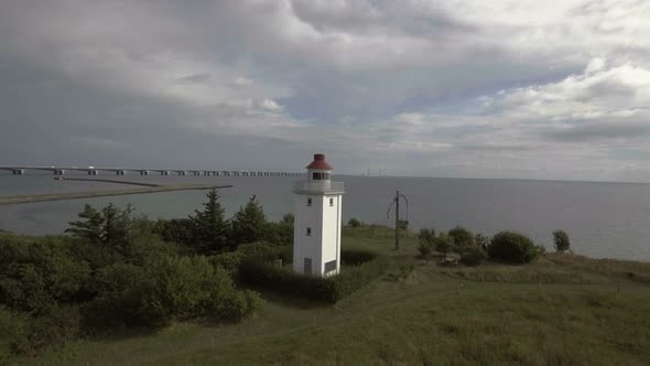 Lighthouse Drone Flies Very Low Towards Lighthouse End In A View Over Ocean