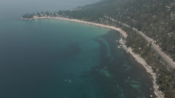 Aerial cinematic view mountain lake road. Road along mountains and lake. alt