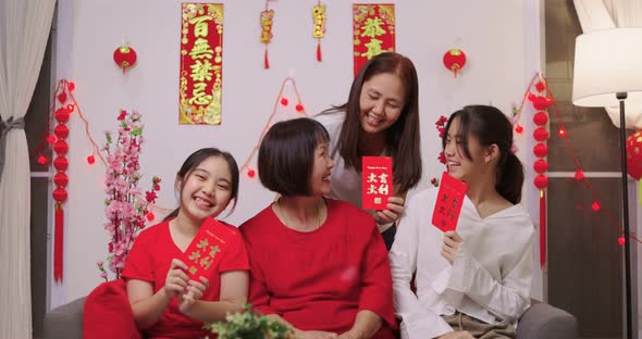 Happy Asian Multi Generations Family Celebrating Chinese New Year. Showing Lucky Red Envelope. alt