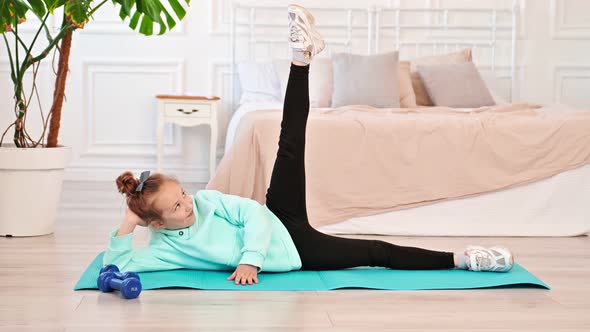 Happy Teen Girl Doing Workout at Home on Sports Mat in Bedroom