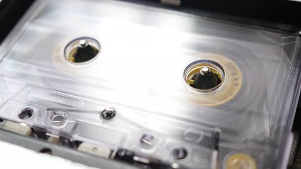 Transparent  audio  tape played in casettophone  close-up 4K 2160p 30fps UltraHD footage -  Music pl