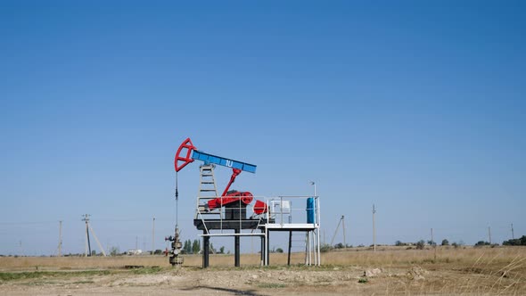 Oil Rig Stands in a Field at and Extracts Minerals alt