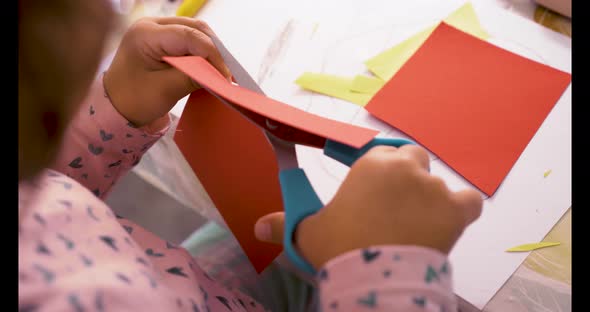 Toddler cutting with scissors and doing crafts