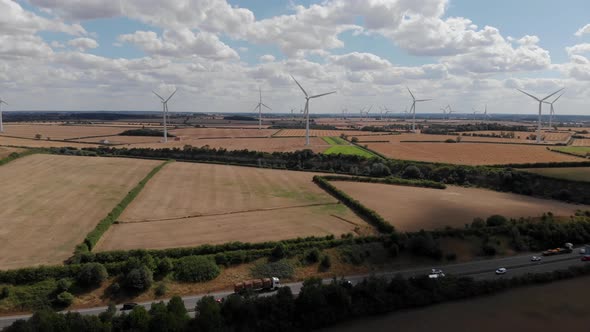 Wind Farm Aerial View Of And A14 Road Cloudy Blue Sky.