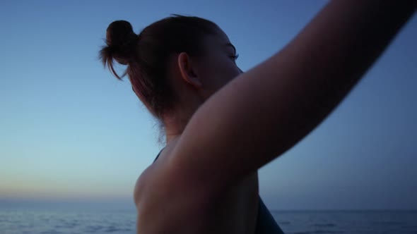 Profile Girl Raising Hands to Dark Sky Close Up alt