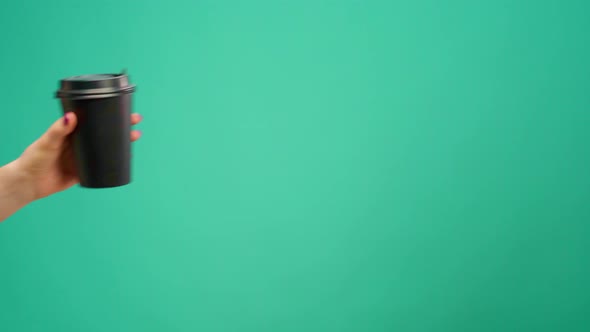 People Hands Passing One Another Cup of Coffee to Go Against Mint Background alt