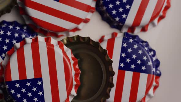 Rotating shot of bottle caps with the American flag printed on them - BOTTLE CAPS  alt