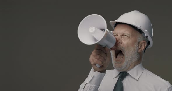 Senior engineer and businessman shouting into a megaphone, marketing and communication concept