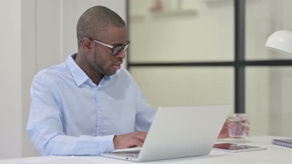African Man Having Toothache While Drinking Water alt