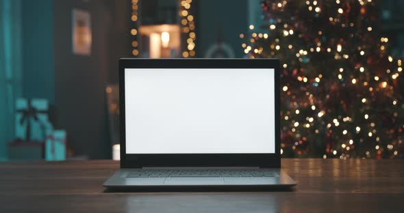 Laptop with blank screen and Christmas tree