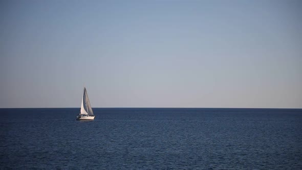 View of Small Yacht Boat Sailing in Calm Open Sea in Montenegro alt