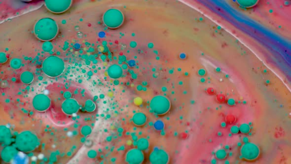 Amazing Multicolored Bubbles of Paint on the Oil Surface. Paint in Oil. alt