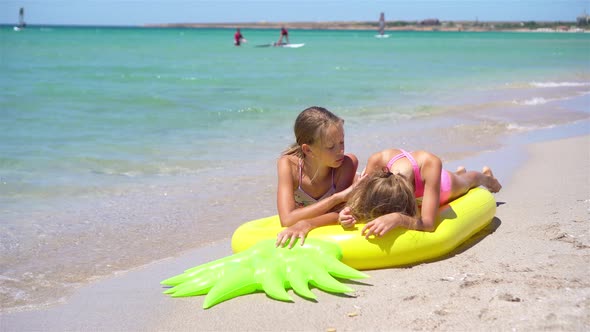 Little Girls Having Fun at Tropical Beach During Summer Vacation Playing Together