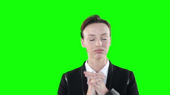 Anxious Caucasian woman looking at camera on green background alt