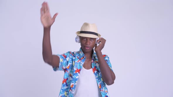 Young Happy African Tourist Man As DJ Using Headphones alt
