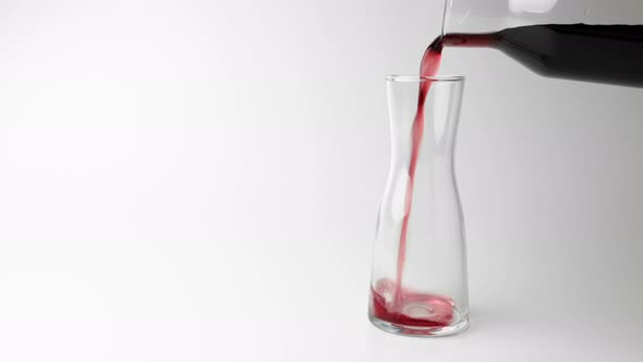 the Wine is Poured Into a Test Tube on a White Background