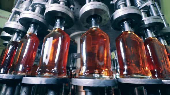 Rotating Transporter with Newlyproduced Alcohol in Bottles alt