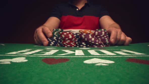 Male Player Betting All Chips in While Playing in Casino Close Up