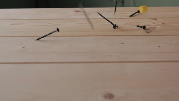 A Lot of Nails Screws and Selftapping Screws Fall on Top of the Wooden Surface