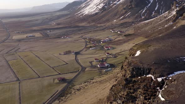 Small Secluded Town Next to a Snowy Mountain in the Winter alt