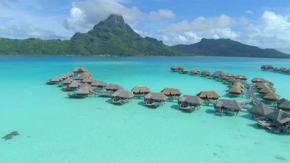 Aerial drone view of a luxury resort and overwater bungalows in Bora Bora tropical island alt