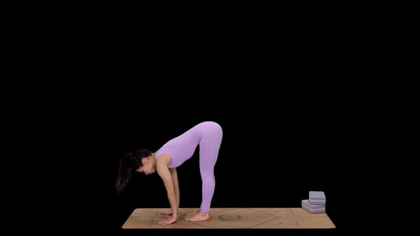 Young Sporty Woman Doing Yoga Standing Half Forward Bend on Mat, Alpha in