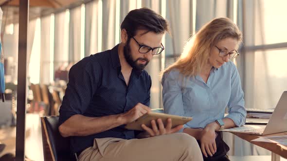 Media Marketing Discussion Meeting. Two Colleague Talking In Office About Business Project. alt