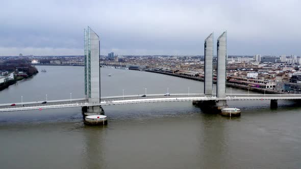Jacques Chaban-Delmas Bridge in Bordeaux France with  car traffic over Garonne river, Aerial lowerin alt