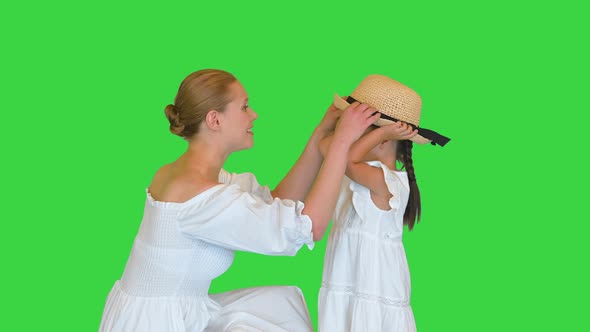 Mother and Daughter Talking with Each Other on a Green Screen Chroma Key alt