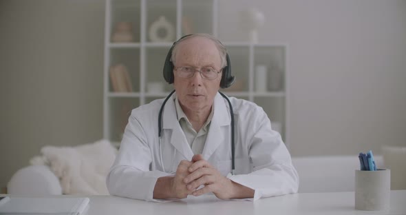 Aged Professor of Medicine Is Lecturing Online From His Office in Clinic, Medium Portrait of Doctor alt
