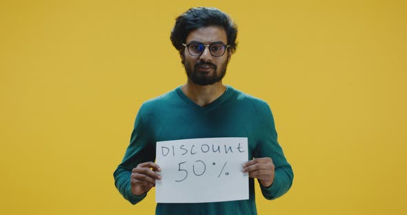 Young Man Holding Discount Sign alt