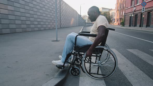 Elderly Black African Disabled Person Crosses Road and Tries Unsuccessfully to Climb Onto Sidewalk alt