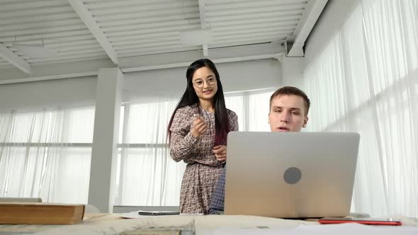 people in office talking on video call with business partner and telling project alt