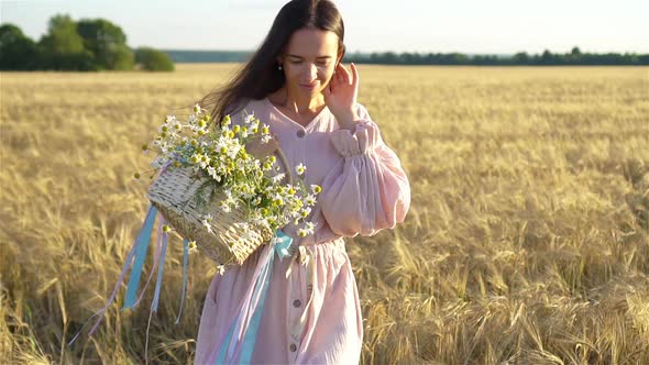 Back View of Girl in Wheat Field, Beautiful Woman in Dress with Ripe Wheat in Hands