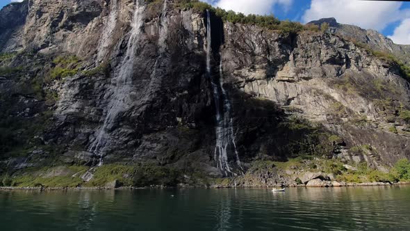 Towering rock walls of the Geiranger Fjord seven sisters Waterfall of Norway alt