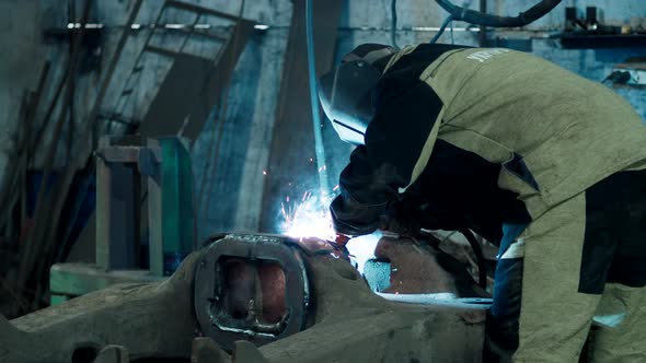 Heavy Industry Welder Welds Metal Parts for Car Repair alt