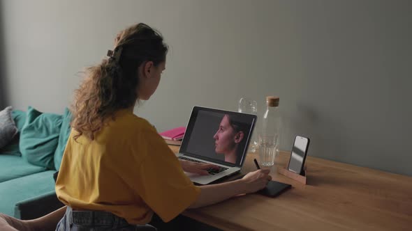Woman Working with Photos on Her Laptop