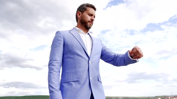 Serious Businessman in Formal Suit Check Wristwatch Waiting in Sky Time