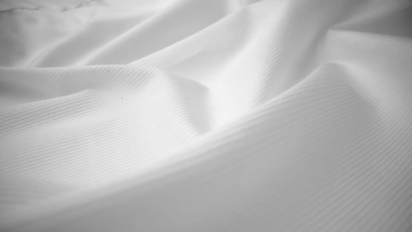 Shiny flowing cloth texture dolly shot in close up view macro shot. alt